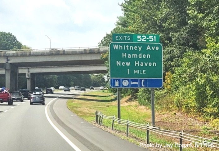 Image of ground mounted 1 Mile advance sign for the Whitney Avenue exits, with 
 new milepost based exit numbers overlay on exit tab on CT 15 South/Cross Parkway in Hamden, 
 by Jay Hogan, August 2025