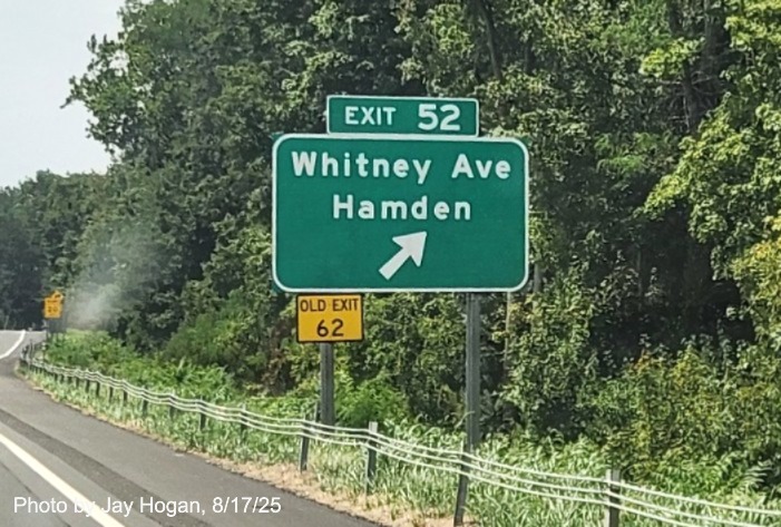 Image of ground mounted ramp sign for the second Whitney Avenue exit, with 
 new milepost based exit number with yellow Old Exit 62 sign on support post on CT 15 South/Cross Parkway in Hamden, 
 by Jay Hogan, August 2025