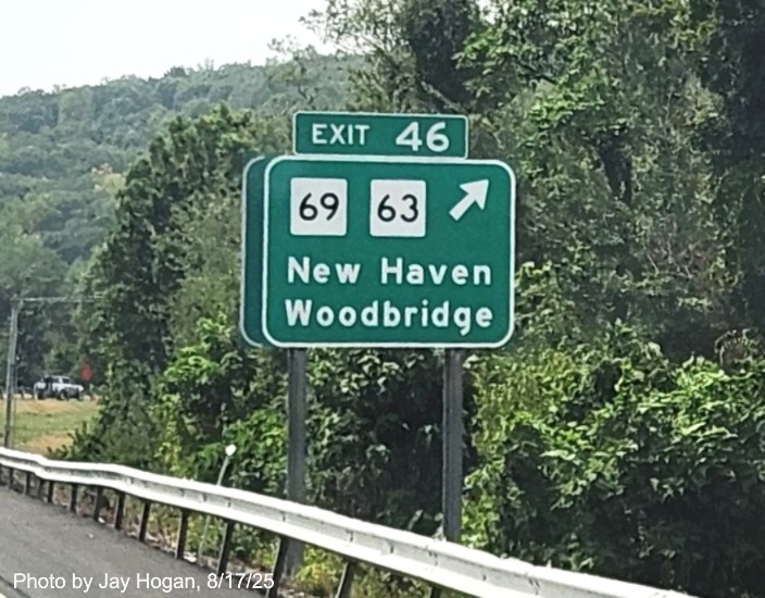 Image of 1 mile advance ground mounted sign for the CT 69/CT 63 exit, with 
 new milepost based exit number on CT 15 South/Cross Parkway in Westville, by Jay Hogan, August 2025