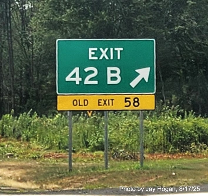 Image of gore sign for the CT 34 West exit, with 
 new milepost based exit number and yellow Old Exit 58 sign below on CT 15 South/Cross Parkway in Derby, by Jay Hogan, August 2025