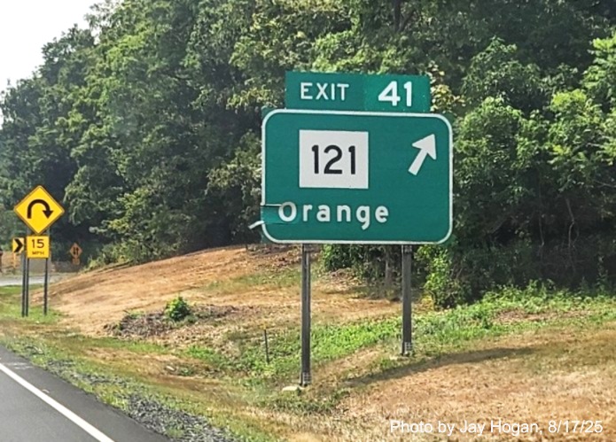 Image of ground mounted exit sign for the CT 121 exit, with 
 new milepost based exit number on CT 15 South/Cross Parkway in Orange, by Jay Hogan, August 2025