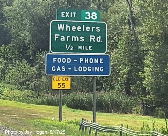 Image of 1/2 mile advance ground mounted sign for the Wheelers Farm Road exit, with 
 new milepost based exit number and yellow Old Exit 55 sign on support post on CT 15 South/Cross Parkway in Milford, by 
 Jay Hogan, August 2025