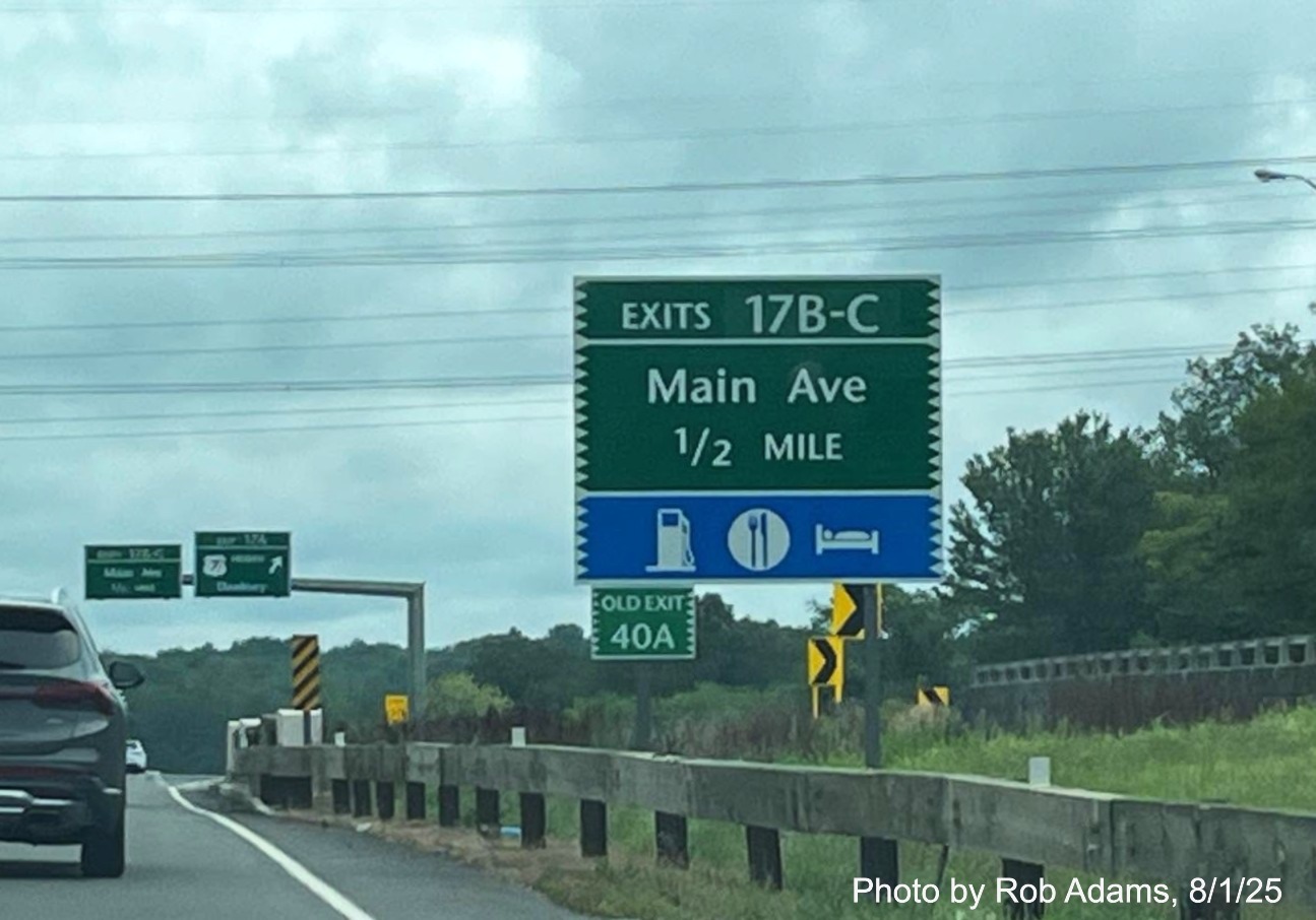 Image of 1/2 Mile advance sign for the Main Avenue South and North exits, now with new 
 milepost based exit numbers and small Old Exit 40A sign on support post on CT 15 North/Merritt Parkway in Norwalk