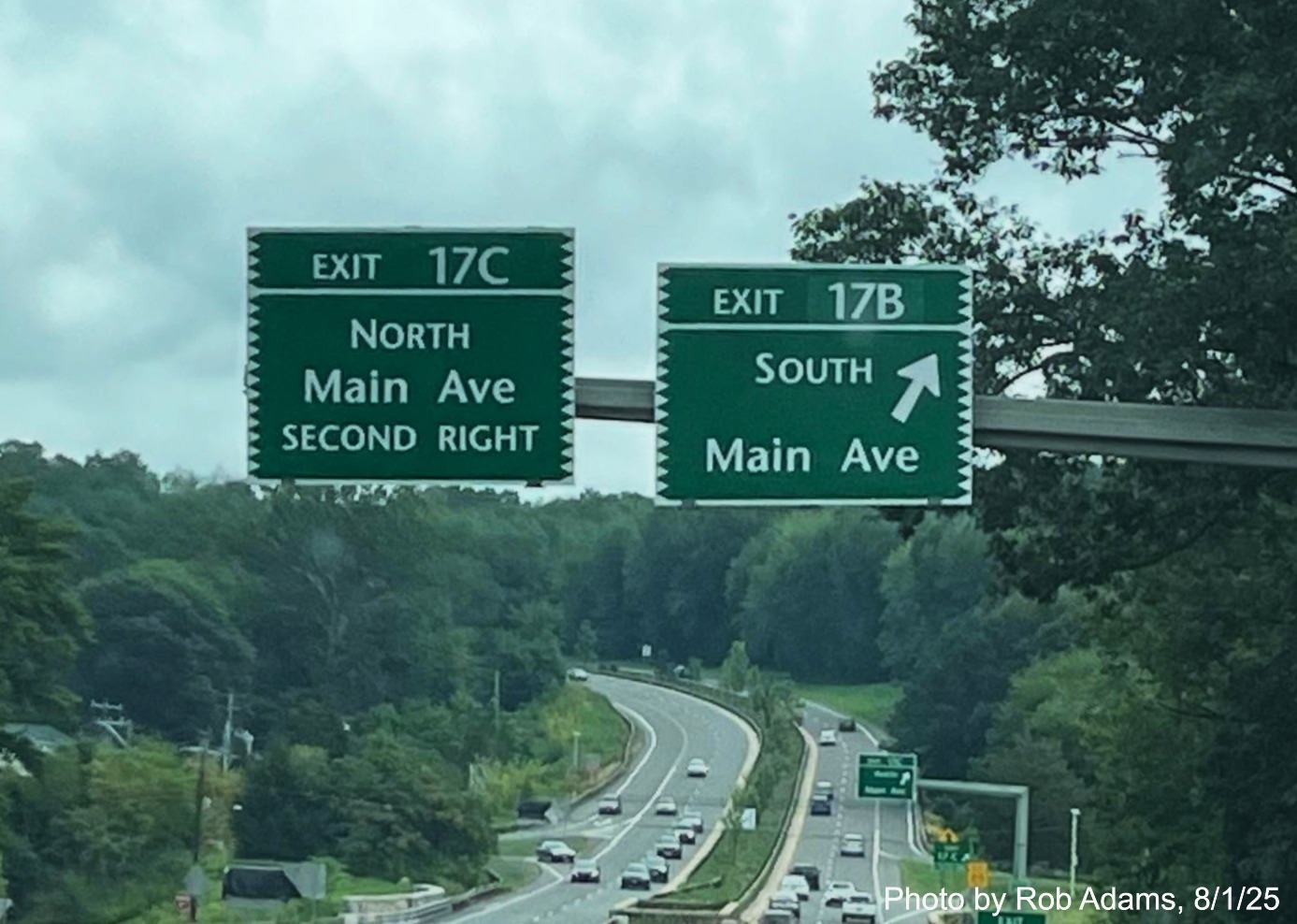 Image of overhead signs at the ramp for the Main Street South exit, now with new 
 milepost based exit numbers on CT 15 North/Merritt Parkway in Norwalk