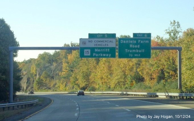 Image of 1 mile advance overhead sign for Daniels Farm Road exit with new milepost based exit number 
       and yellow Old Exit 8 sign attached to support post on CT 25 South in Trumbull, by Jay Hogan, October 2024