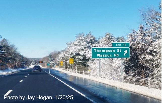 Image of ground mounted ramp sign for Thompson Avenue exit with new milepost based
	  exit number on CT 2 West in East Glastonbury, by Jay Hogan, January 2025