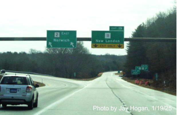 Image of overhead signs at ramp for CT 11 exit with old sequential exit number on CT 2 East 
    in Colchester, by Jay Hogan, January 2025