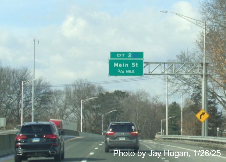 Image of 1/2 mile advance sign for Main Street exit with new milepost based
	  exit number and covered letter on CT 2 West in East Hartford, by Jay Hogan, January 2025