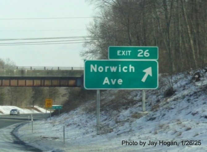 Image of ground mounted ramp sign for Norwich Avenue exit with new milepost based
	  exit number on CT 2 East in Colchester, by Jay Hogan, January 2025