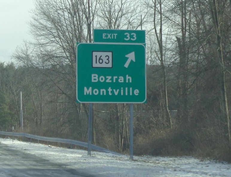 Image of ground mounted ramp sign for CT 163 exit with new milepost based
	  exit number on CT 2 East in Bozrah, by Jay Hogan, January 2025