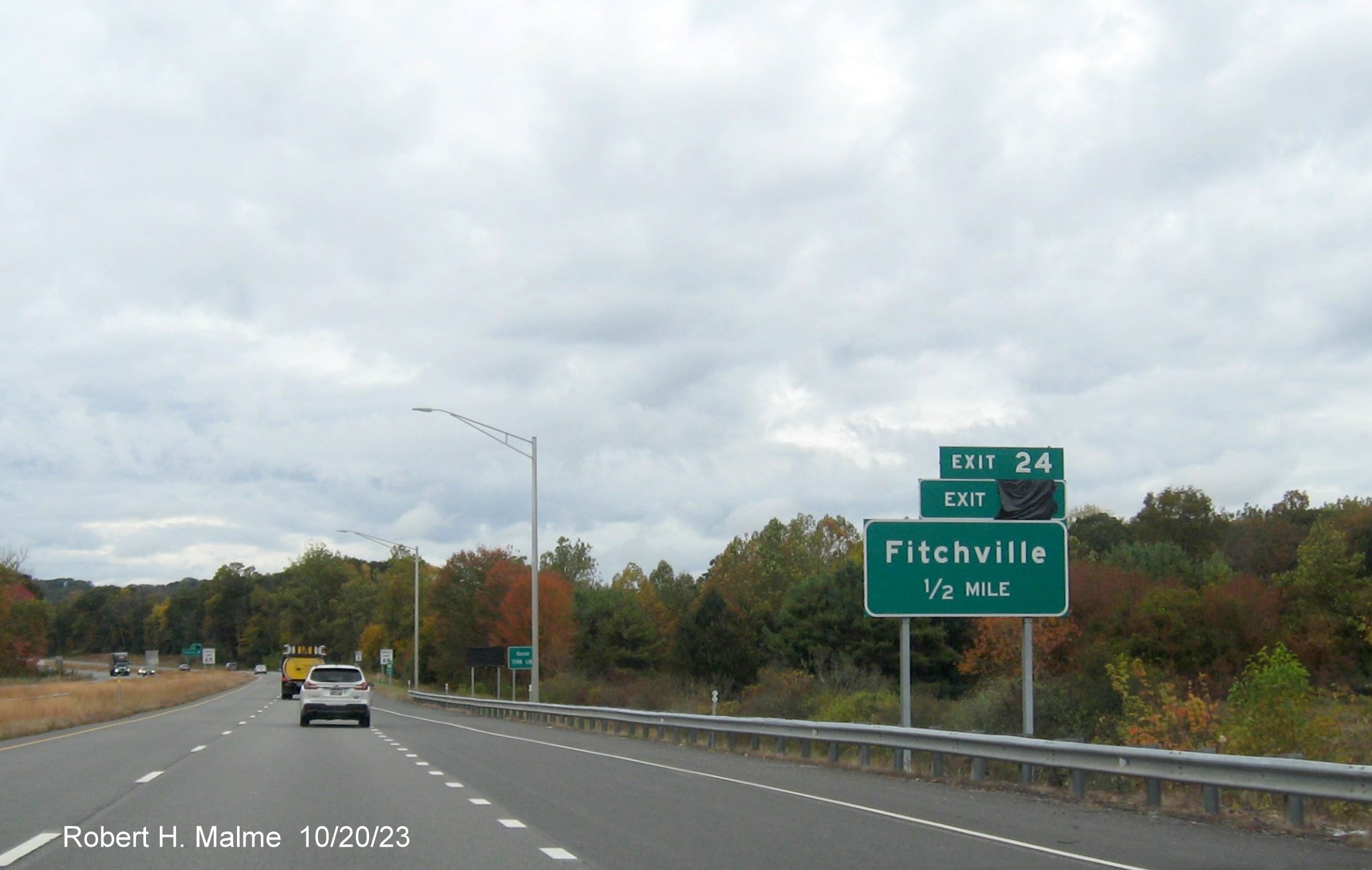 Image of new 1 mile advance sign for Fitchville exit on CT 2 West in Norwich with future milepost exit number
      (34) covered over and exit tab from former sign put on top as temporary exit tab, October 2023
