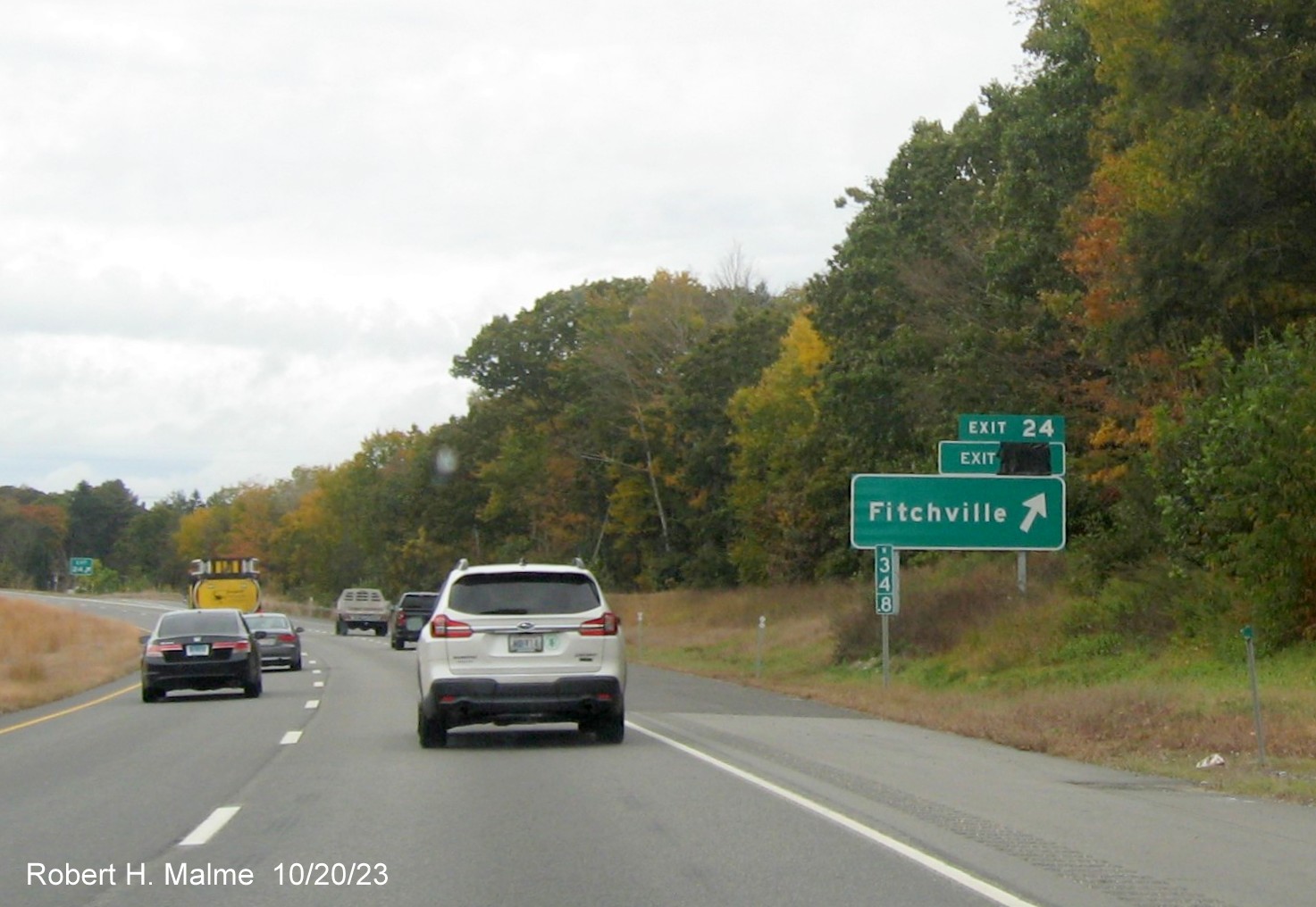 Image of new ground mounted ramp sign for Fitchville exit on CT 2 West with covered up future milepost 
      based exit number and exit tab from old sign on top, October 2023