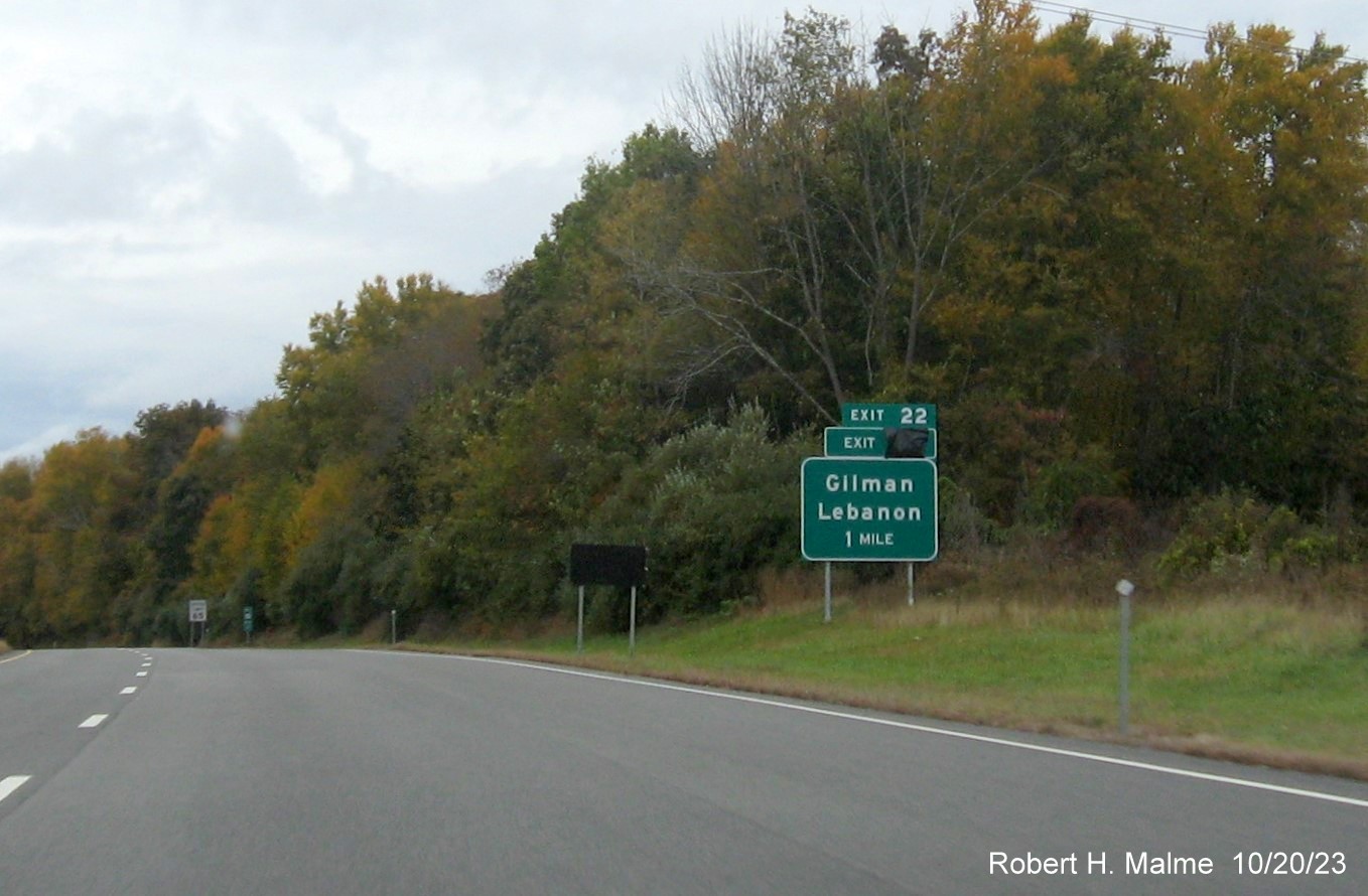 Image of new 1 mile advance sign for Gilman/Lebanon exit on CT 2 West with covered 
      over future exit number (30) and Old Exit 22 sign, October 2023
