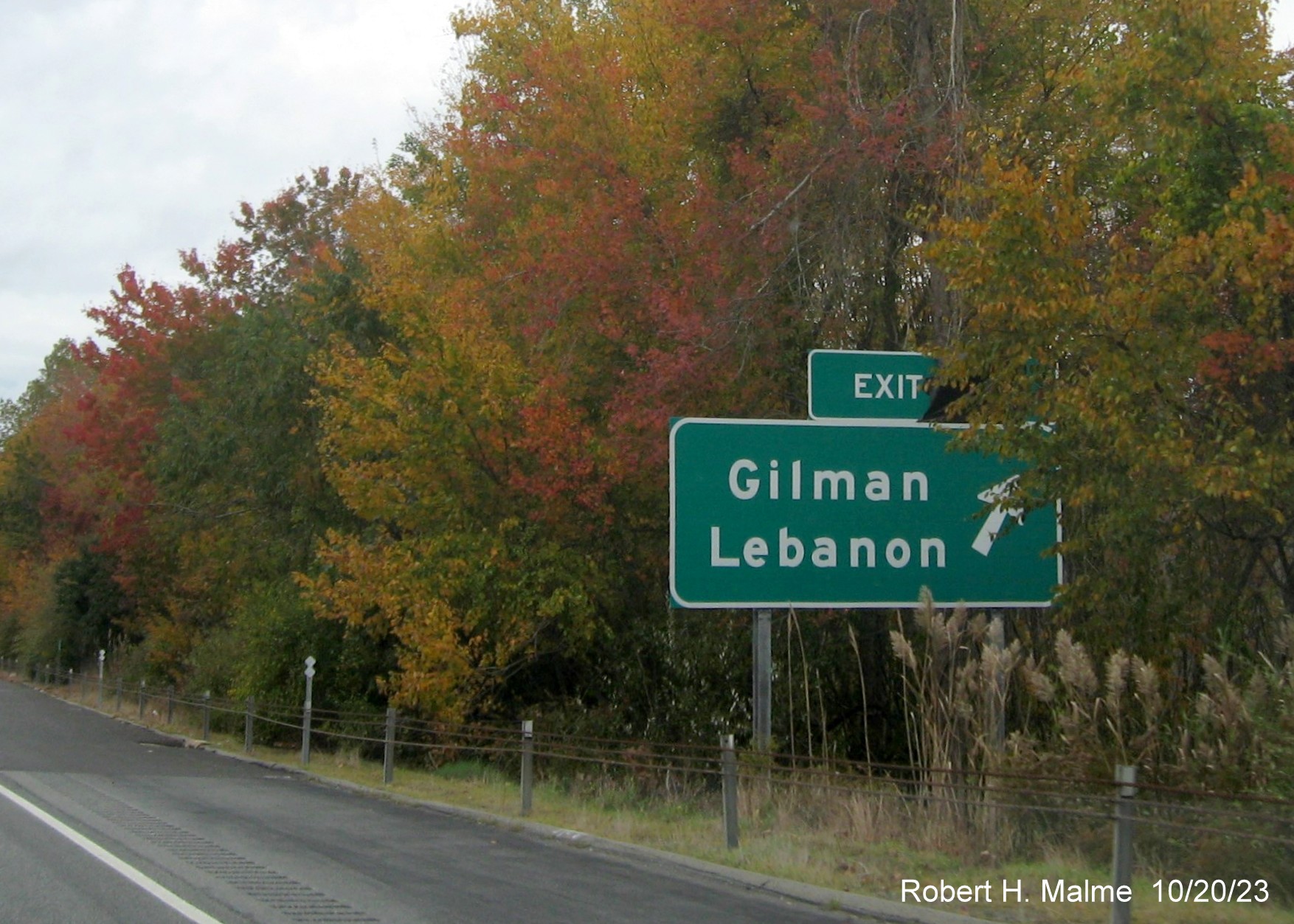 Image of new ground mounted ramp sign for Gilman/Lebanon exit on CT 2 West with covered 
      over future exit number (33) and also Old Exit 23 sign, October 2023