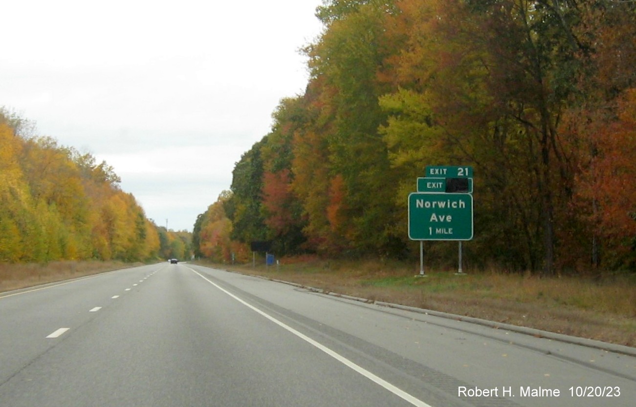 Image of new 1 mile advance sign for Norwich Avenue exit on CT 2 West in Colchester with covered 
      over future exit number (26) but no Old Exit 21 sign, October 2023
