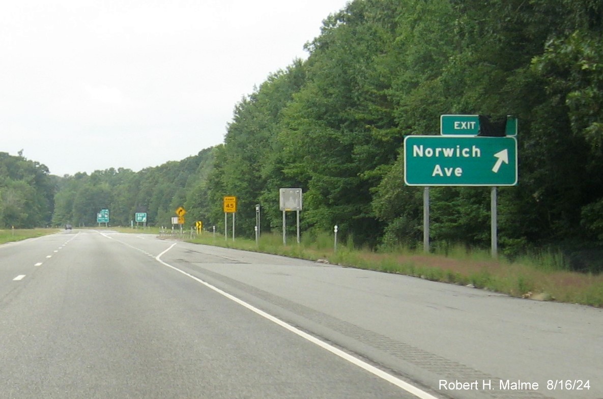 Image of ramp sign for Norwich Avenue exit still with covered over future milepost based exit number on CT 2 West, August 2024