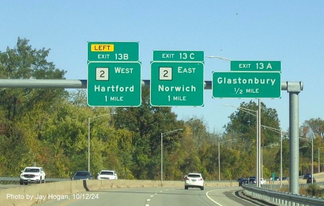 Image of recently placed overhead advance signs for CT 2/Glastonbury exits with new milepost based 
      exit numbers on CT 3 North in Glastonbury, by Jay Hogan, October 2024