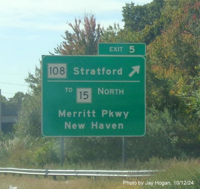 Image of overhead ramp sign for CT 15 North/CT108 exit with new milepost based exit number on CT 8 
        South in Trumbull, by Jay Hogan, October 2024