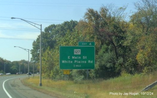 Image of ground mounted 1 mile advance sign for CT 127 exit with new milepost based exit number on CT 8 
        South in Trumbull, by Jay Hogan, October 2024