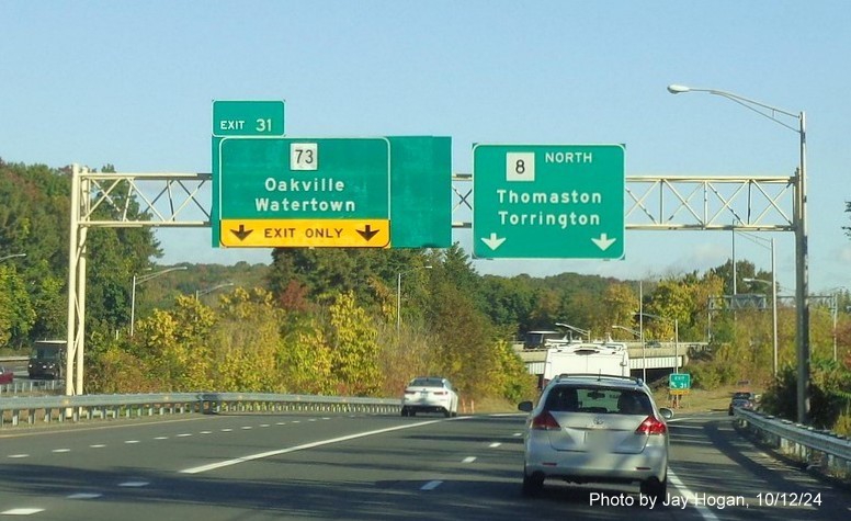 Image of overhead signage for I-84 and Downtown Waterbury exits with new milepost based 
        exit numbers on CT 8 North in Waterbury, by Jay Hogan, October 2024