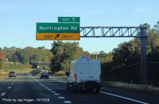 Image of overhead ramp sign for the Hungtington Road exit with new milepost based exit number on CT 8 
        North in Shelton, by Jay Hogan, October 2024