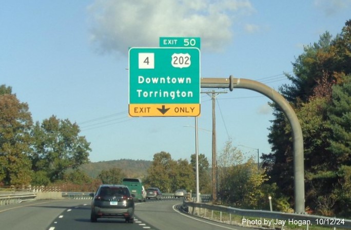 Image of overhead signage for CT 4/US 202 exit with new milepost based 
        exit number on CT 8 North in Torrington, by Jay Hogan, October 2024