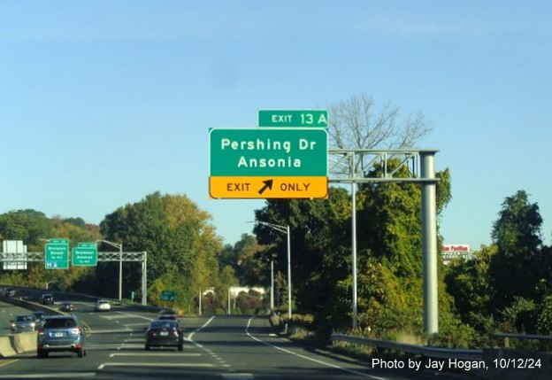 Image of overhead ramp sign for Pershing Drive exit with new milepost based exit number on CT 8 
        North in Derby, by Jay Hogan, October 2024