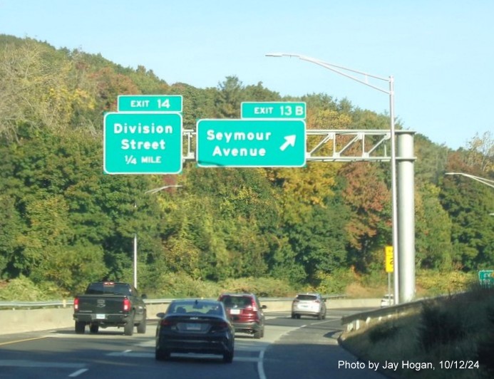 Image of overhead ramp sign for Seymour Avenue exit with new milepost based exit number on CT 8 
        North in Derby, by Jay Hogan, October 2024