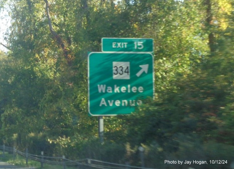 Image of overhead ramp sign for Division Street exit with new milepost based exit number on CT 8 
        North in Derby, by Jay Hogan, October 2024