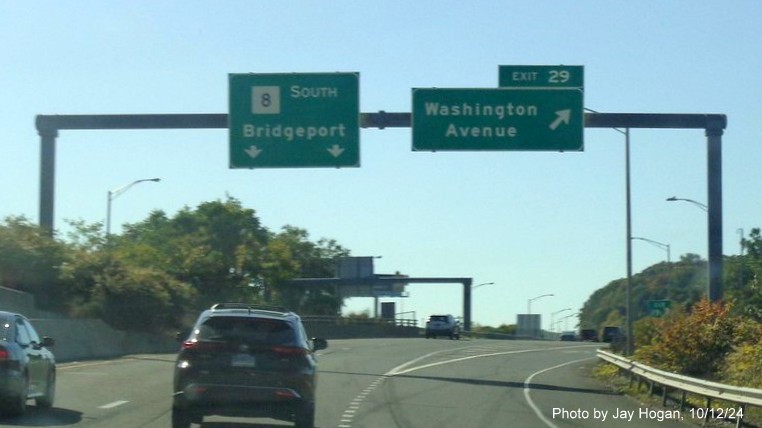 Image of overhead ramp sign for Washington Avenue exit with new milepost based 
        exit numbers on CT 8 South in Waterbury, by Jay Hogan, October 2024