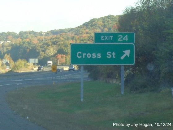 Image of ground mounted ramp sign for Cross Street exit with new milepost based exit number on CT 8 
        North in Naugatuck, by Jay Hogan, October 2024