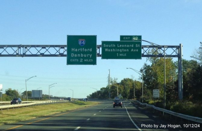 Image of overhead ramp sign for South Leonard Street exit with new milepost based exit number on CT 8 
        North in Waterbury, by Jay Hogan, October 2024