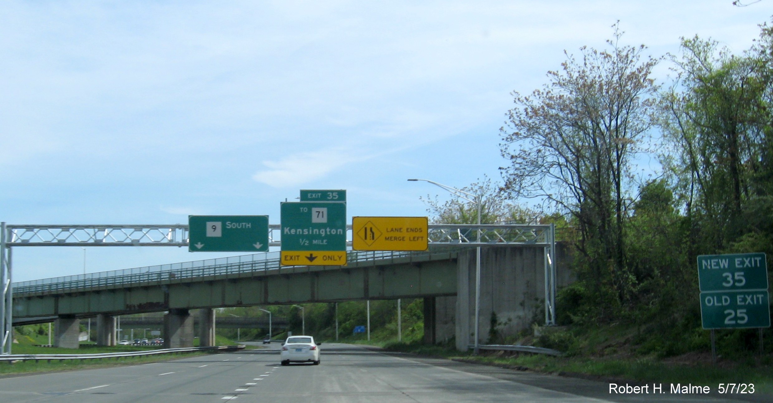 Image of 1/2 Mile advance overhead sign for To CT 71 exit with new milepost based exit number and separate New Exit/Old Exit number sign on CT 9 South in New Britain, May 2023
