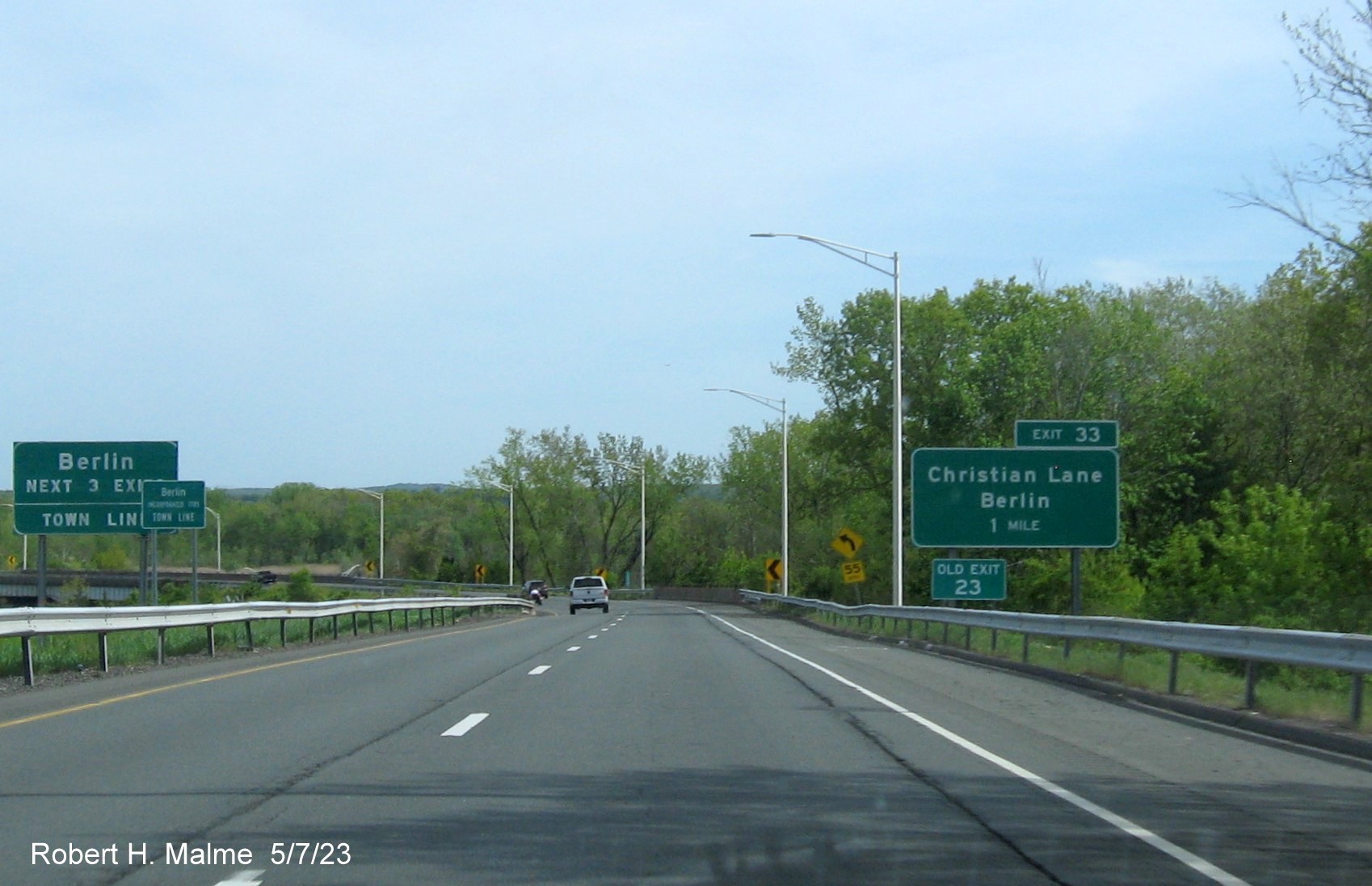 Image of ground mounted 1 Mile advance sign for Christian Lane exit with new milepost based exit number and Old Exit 23 
      sign attached below on CT 9 South in Berlin, May 2023