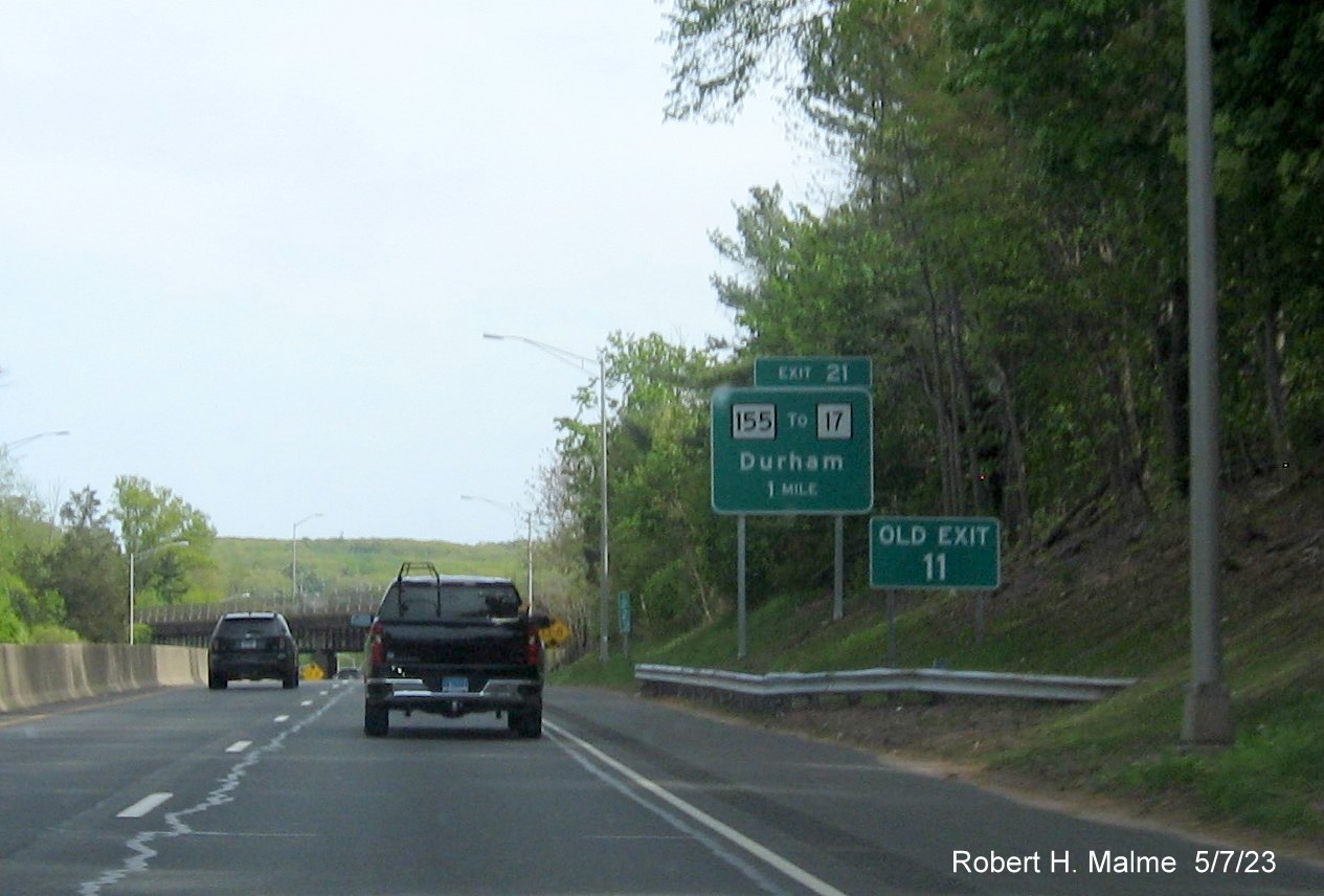 Image of 1 mile advance overhead sign for CT 155 exit with new milepost based exit number and separate Old Exit 11 sign in front on CT 9 South in Durham, May 2023