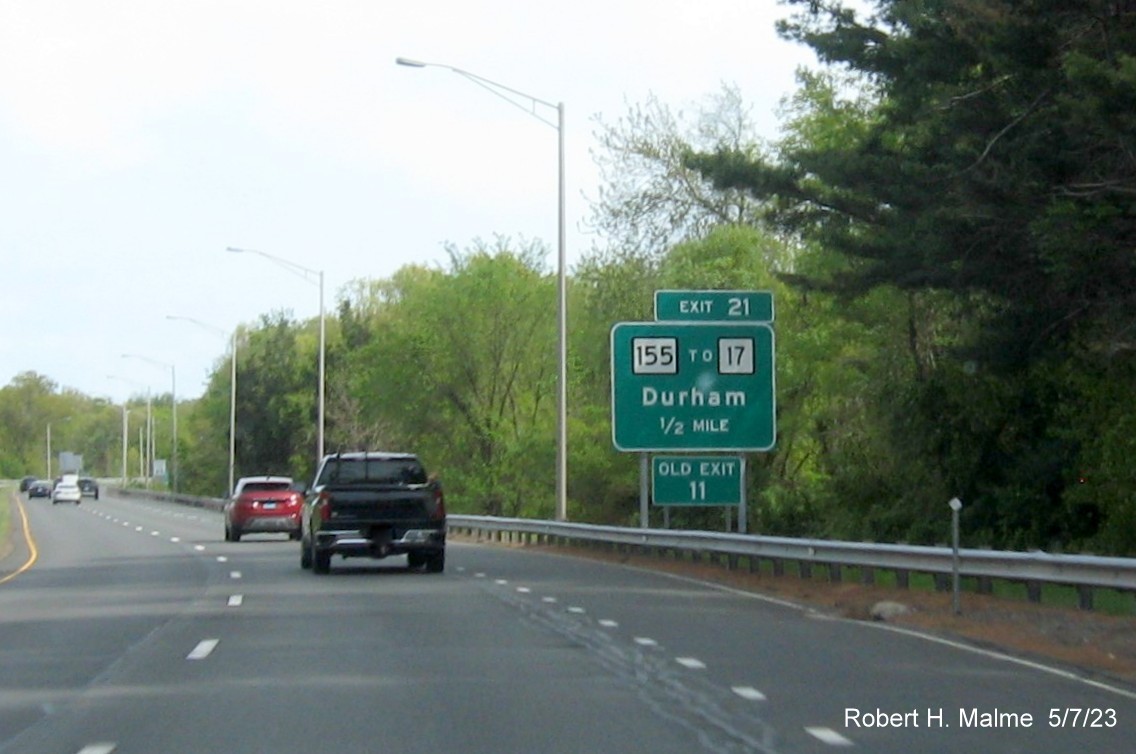 Image of 1/2 mile advance overhead sign for CT 155 exit with new milepost based exit number and separate Old Exit 11 sign in front on CT 9 South in Durham, May 2023