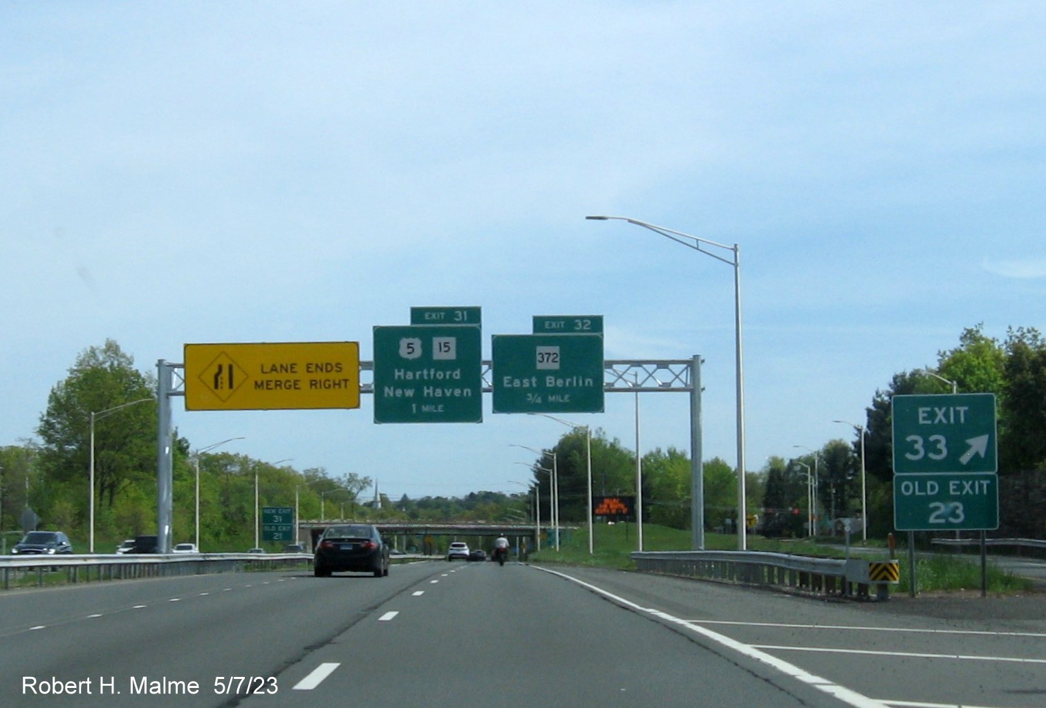 Image of ground mounted 1 Mile advance sign for Christian Lane exit with new milepost based exit number and Old Exit 23 
      sign attached below on CT 9 South in Berlin, May 2023