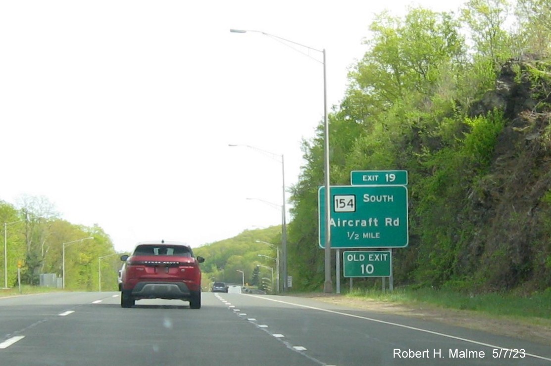 Image of 1/2 mile advance overhead sign for CT 154 exit with new milepost based exit number and separate Old Exit 10 sign in front on CT 9 South in Durham, May 2023