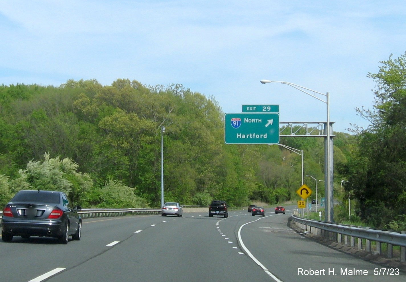 Image of 1/4 Mile advance overhead sign for I-91 North exit with new milepost based exit number and separate Old Exit 20S sign on CT 9 South in Cromwell, May 2023