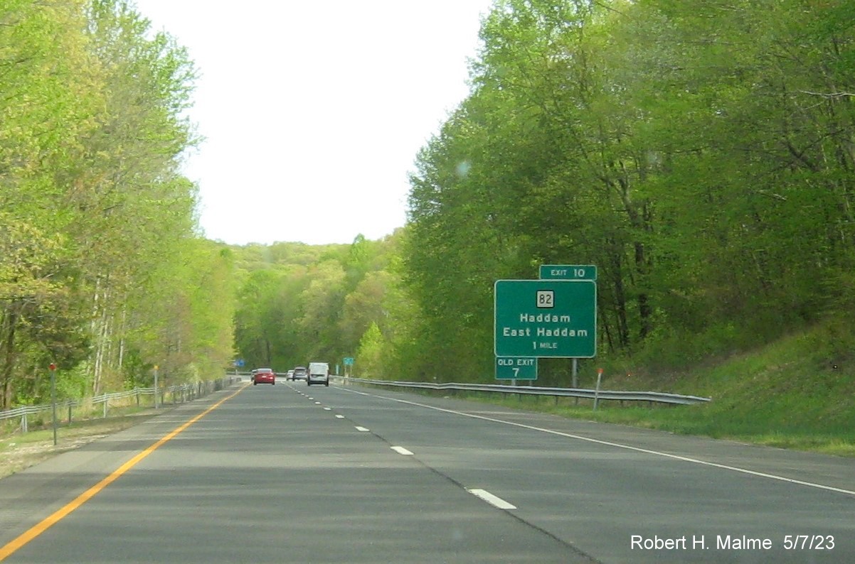 Image of ground mounted 1 mile advance sign for CT 82 exit with new milepost based exit number and Old Exit 7 sign attached below on CT 9 South in Haddam, May 2023