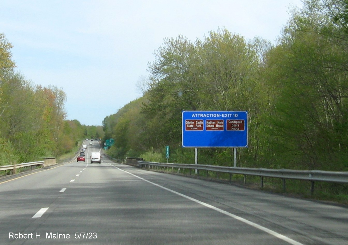 Image of ground mounted blue Attractions services sign for the CT 82 exit with new milepost based exit number on CT 9 South in Haddam, May 2023