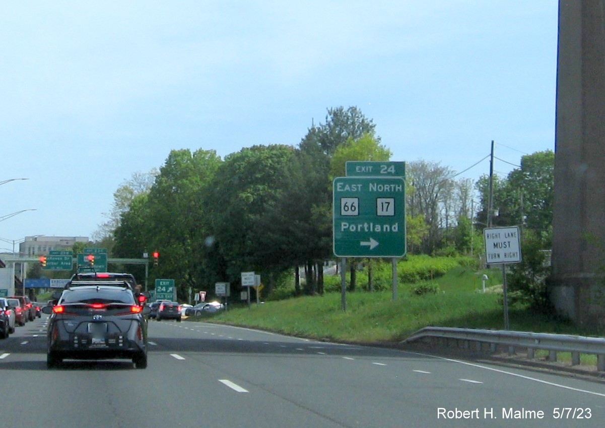 Image of ground mounted ramp sign for East CT 66/North CT 17 'exit' with new milepost based exit number and Old Exit 17 sign attached below on CT 9 South in Middletown