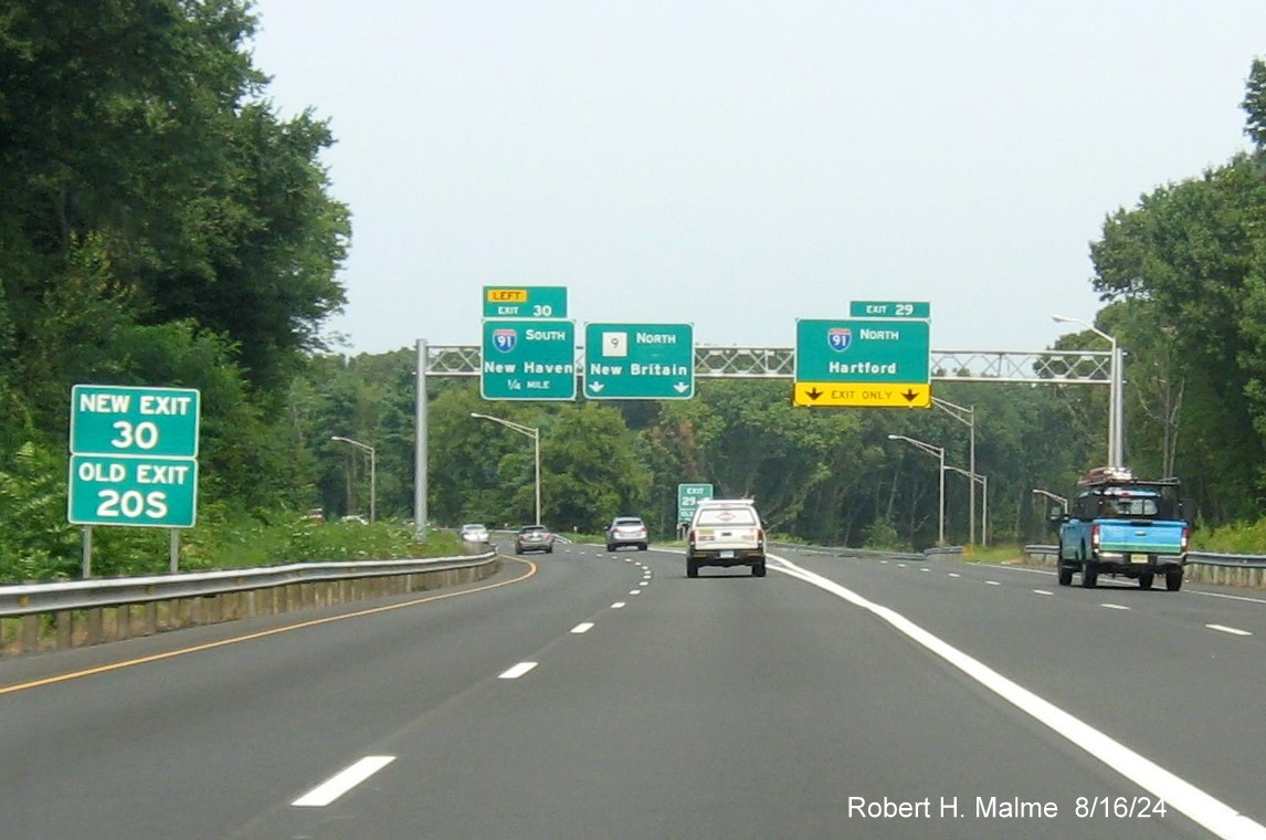 Image of 1/4 Mile advance overhead sign for I-91 South exit with new milepost based exit number and 
      separate New and Old Exit sign in front on CT 9 North in Cromwell, August 2024