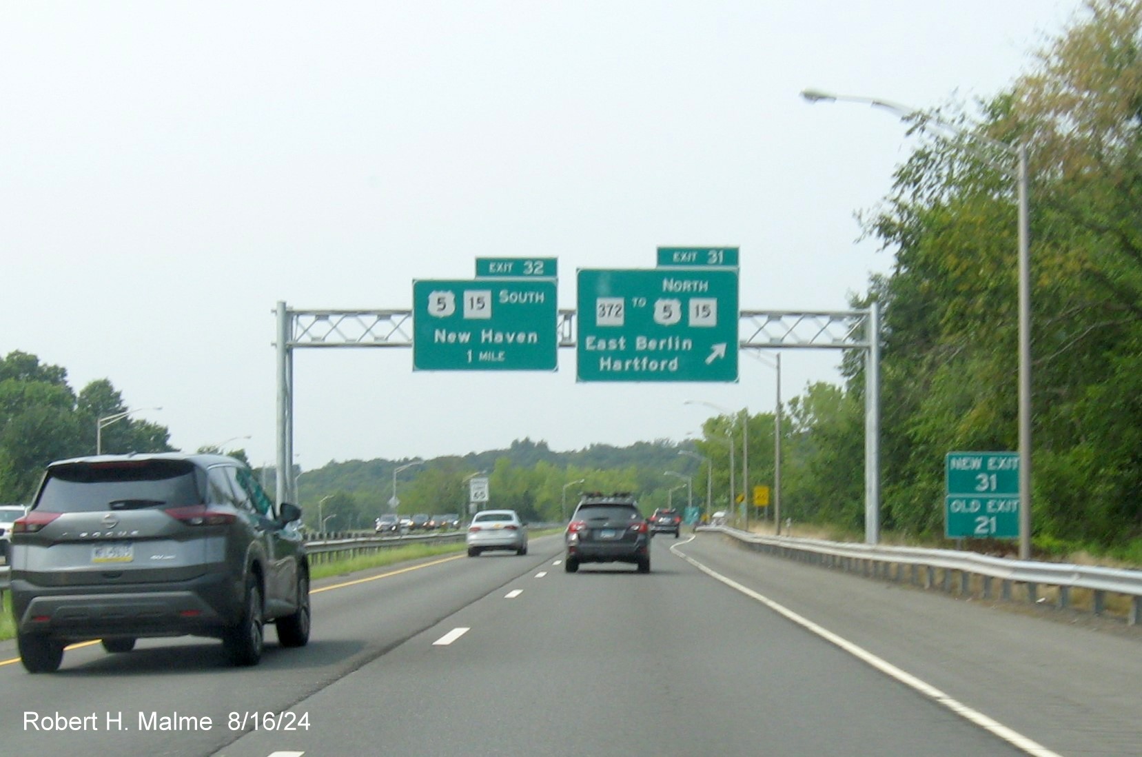 Image of advance signs for US 5/CT 15 South exit and exit sign for CT 372 exit with new milepost based exit 
      number and  separate New and Old Exit signs in front on CT 9 North in East Berlin, August 2024