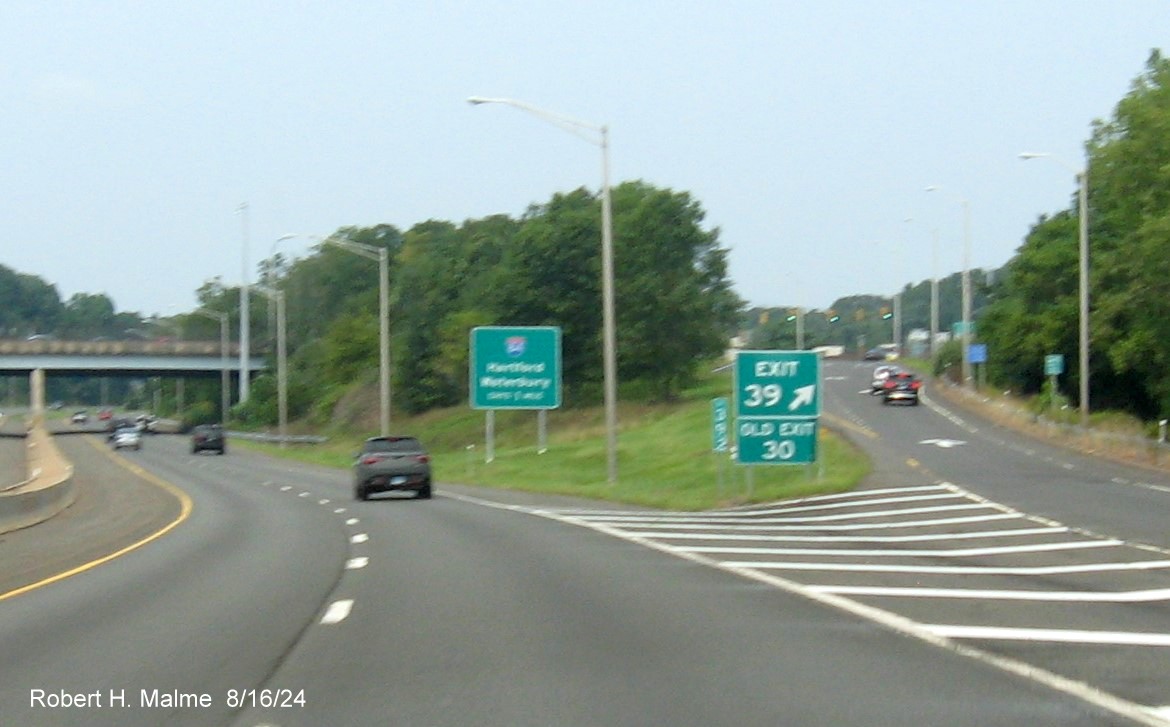 Image of gore sign for CT 71 exit with new milepost based exit number and 
      separate Old Exit sign attached on CT 9 North in Newington, August 2024