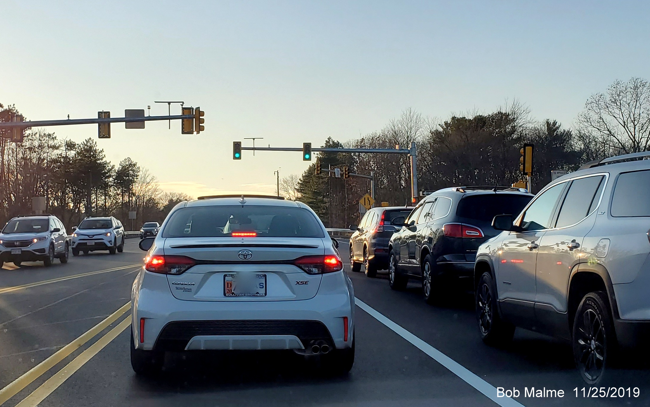 Image of activated green traffic signal on Derby Street in Hingham headed west at ramp from MA 3 North in Nov. 2019