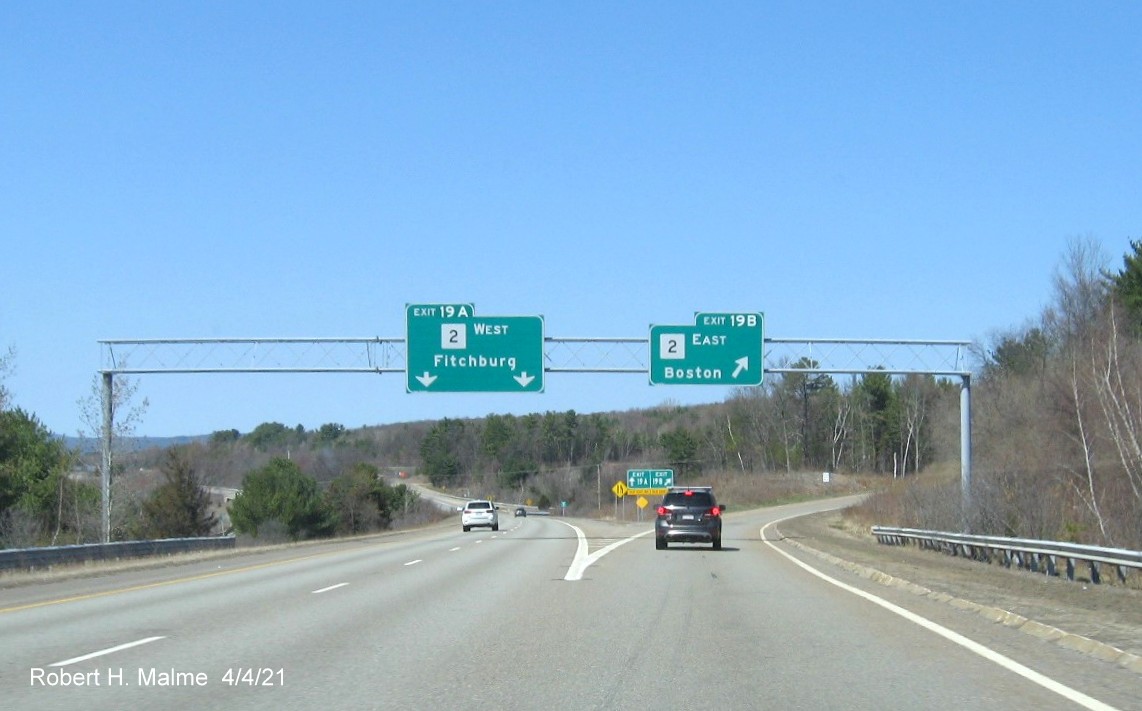 Image of overhead signage at split of ramps for MA 2 exit with new milepost based exit numbers I-190 North in Leominster, April 2021