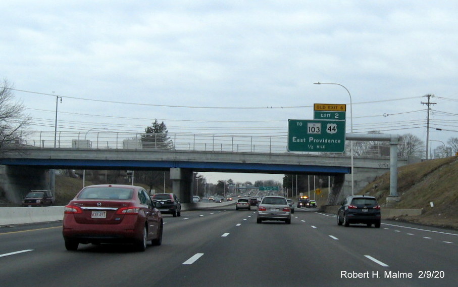 Image of overhead 1/2 mile advance sign with new milepost based number and yellow old exit tab on I-195 West in East Providence