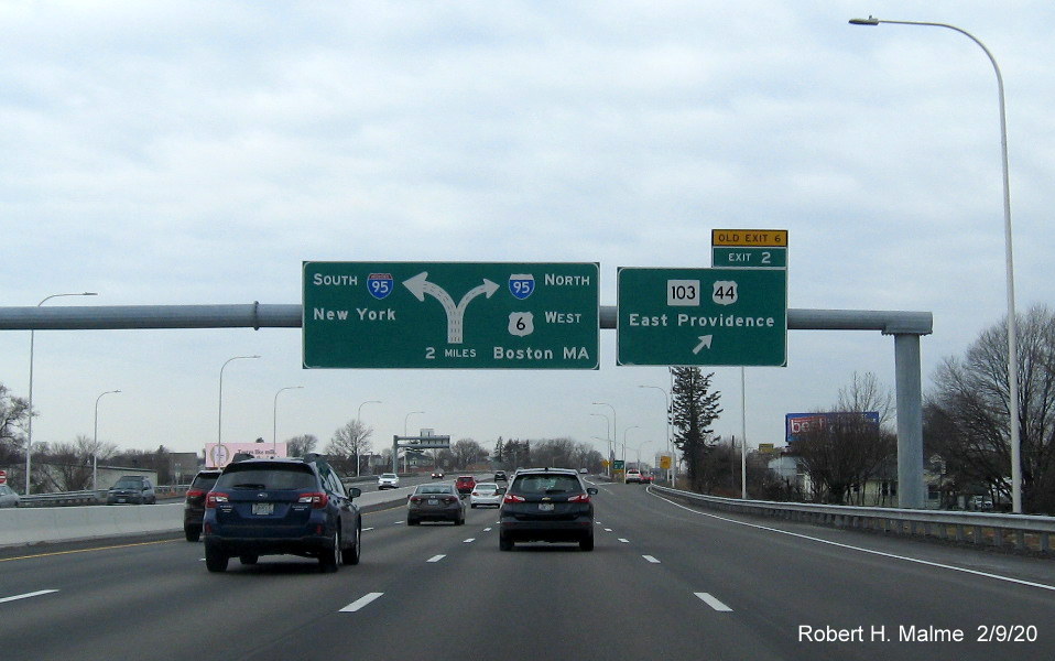 Image of overhead ramp sign for To RI 102, US 44 exit with new milepost exit number and yellow old exit tab on I-195 West in East Providence