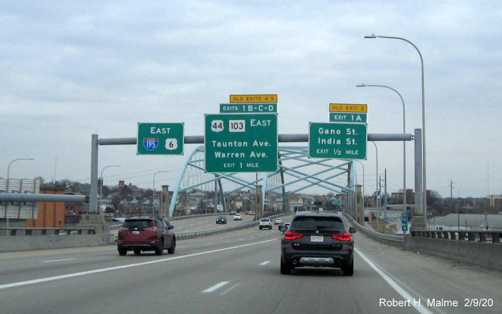 Image of overhead signage with new milepost based exit numbers and yellow old exit tabs on I-195 East in Providence